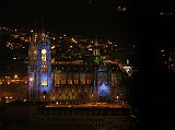 Ecuador Quito 07-08 Old Quito Cafe Mosaico Sunset View Of Basilica del Voto Nacional From Cafe Mosaico the lights of Old Quito came on, with this close up view of the Bas�lica del Voto Nacional, the tallest church in Ecuador with its twin 115m towers, modeled after the Cathedral of Notre Dame in Paris.